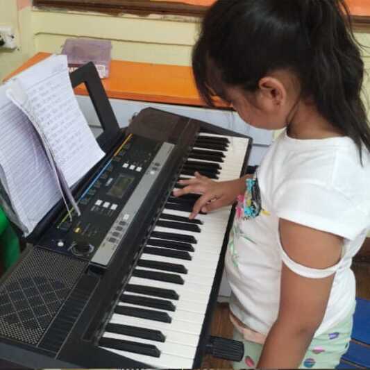 Young student playing the synthesizer at Natraj Sangeet Center